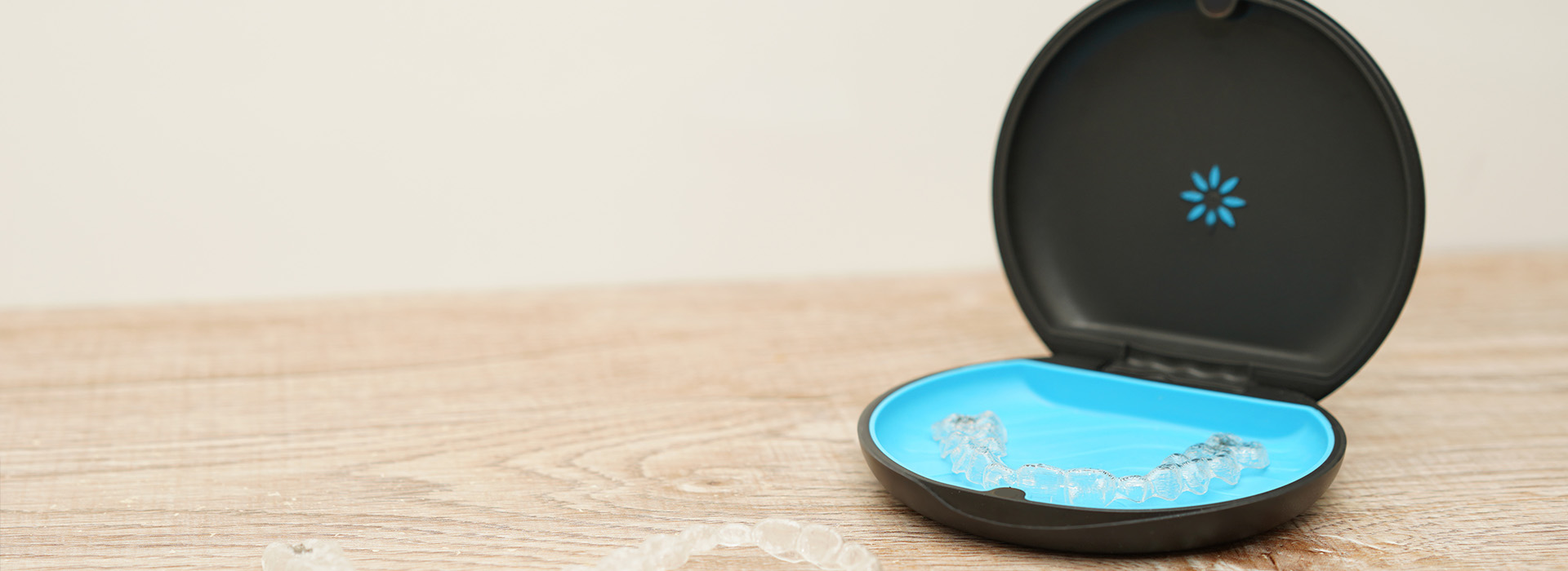 An image of a small, round electronic device with a blue top on a surface.