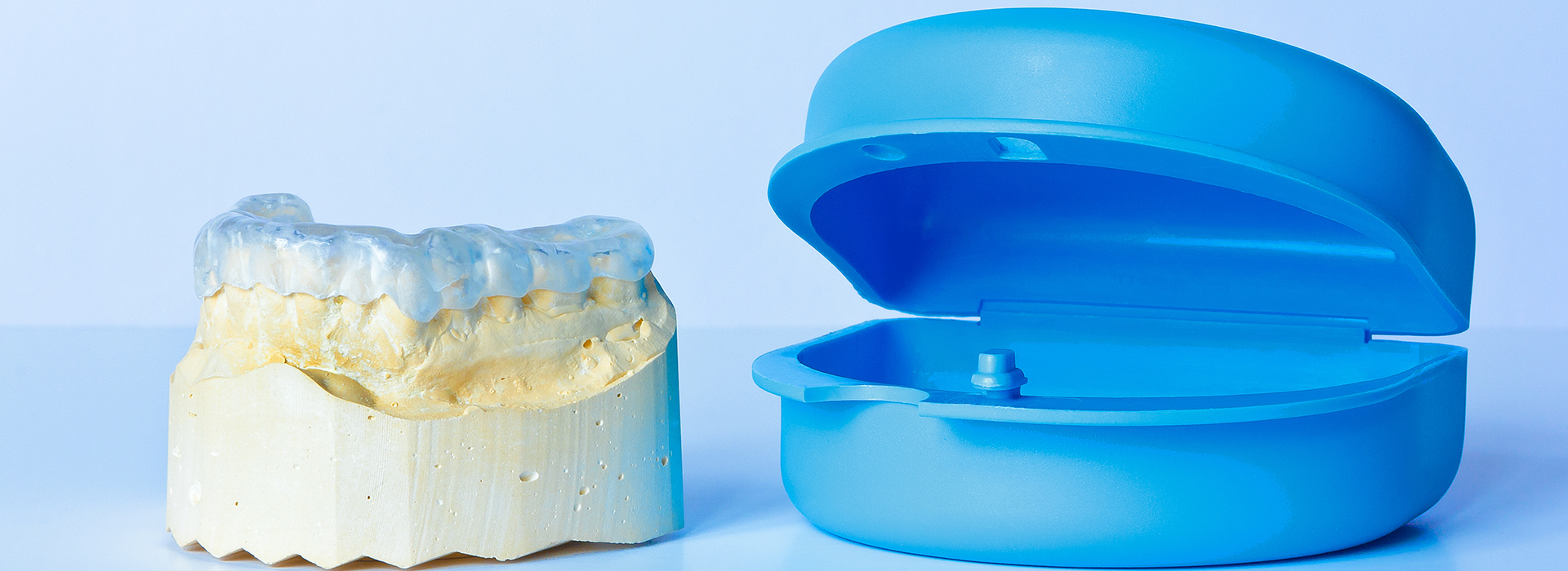 An image featuring two blue dental molds placed side by side, with one mold appearing slightly more filled than the other.